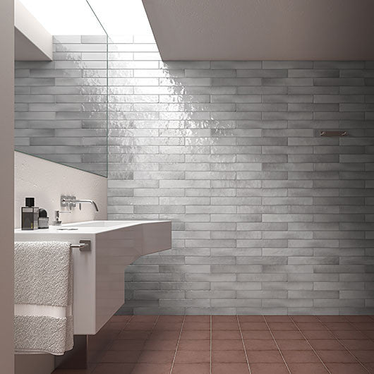 Bathroom with gray tiled wall and white sink